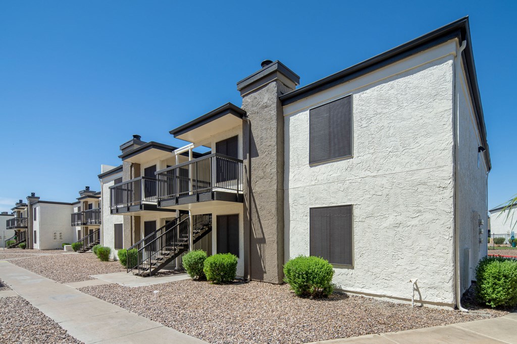 A row of houses with a clear blue sky above them.