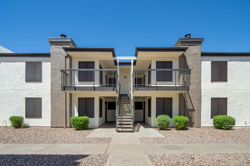 A two-story building with a balcony on the second floor.