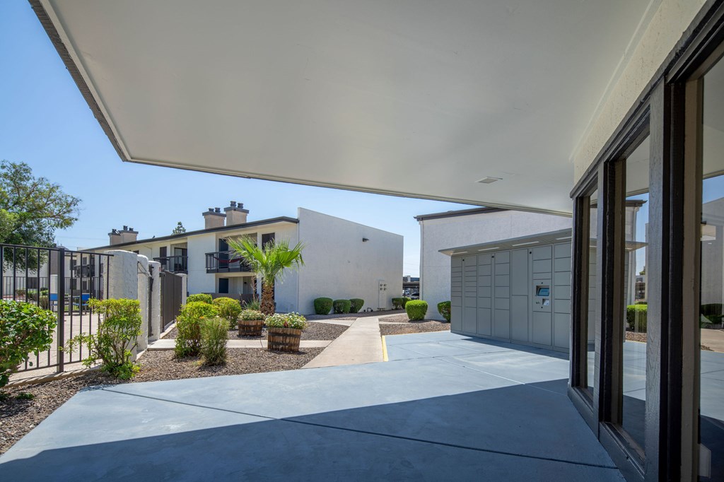 A modern building with a white overhang and glass doors.