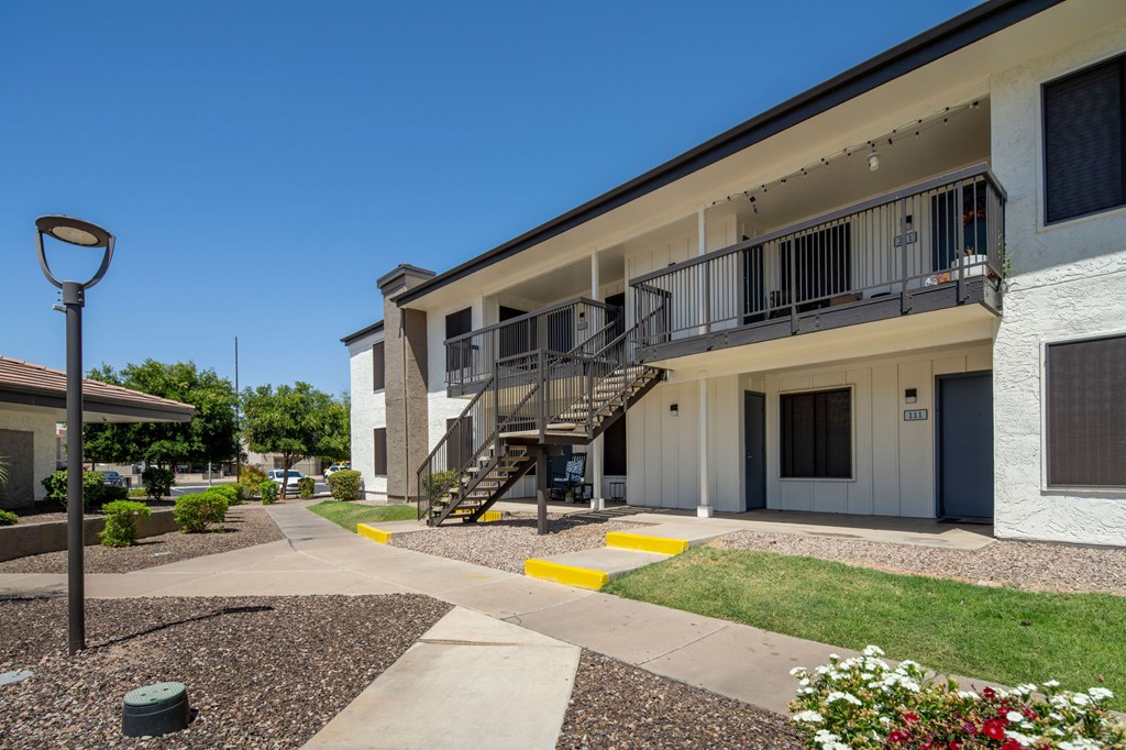 A sunny day at a residential complex with a clear blue sky.