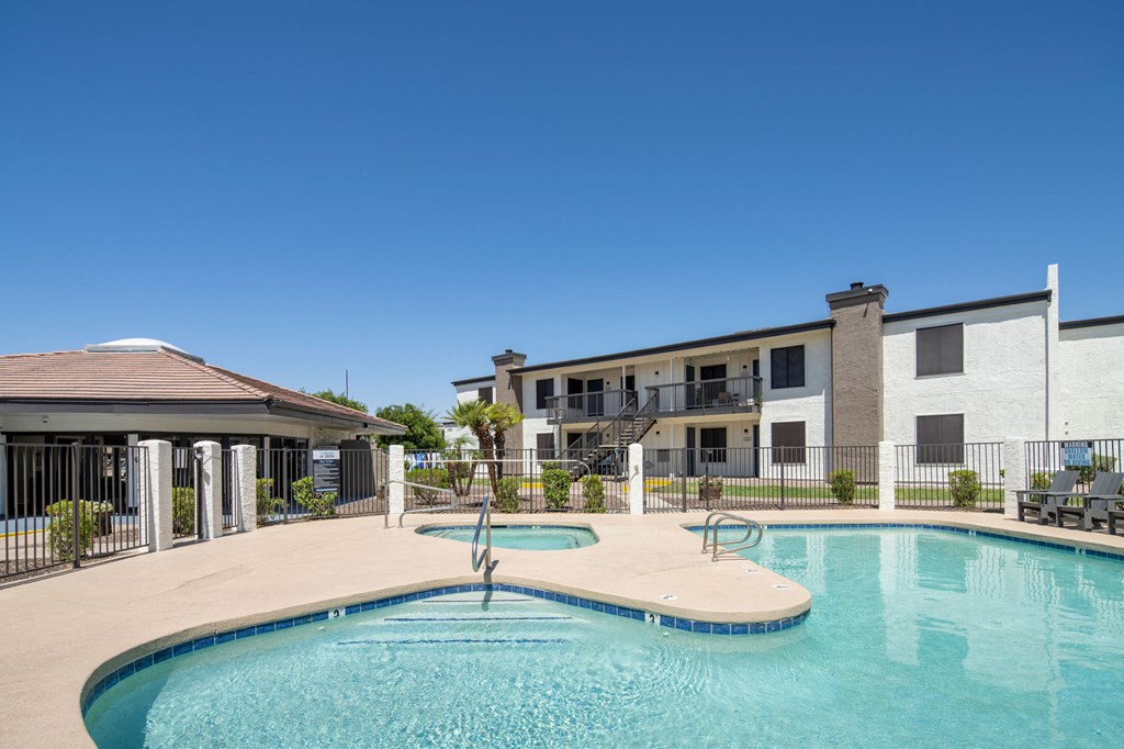 A swimming pool with a fountain in the middle of it.