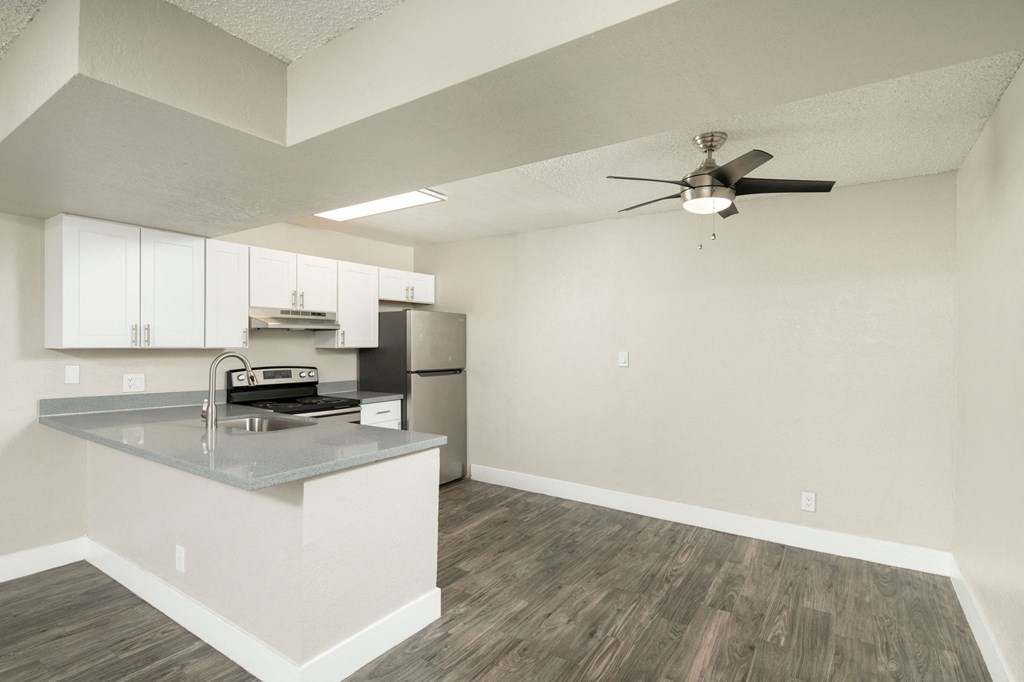 A kitchen with a countertop and a fan.