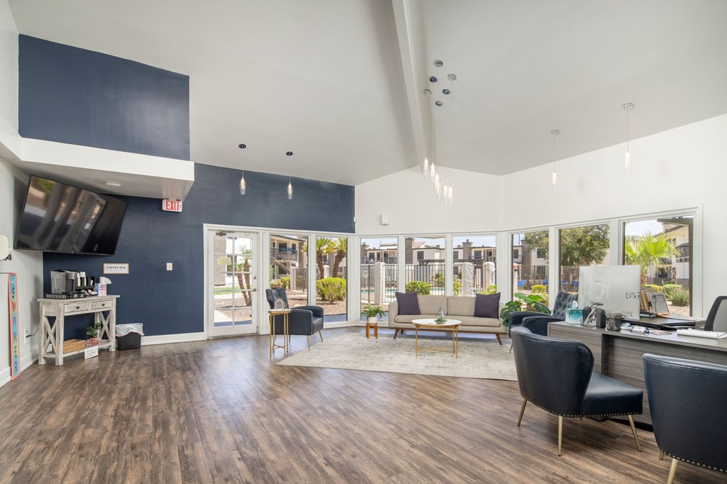 A spacious office with a view of the outside through large windows.