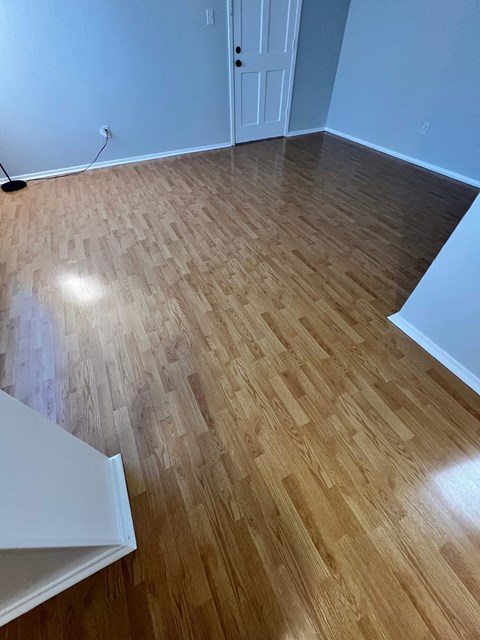 a living room with wood flooring and a blue wall