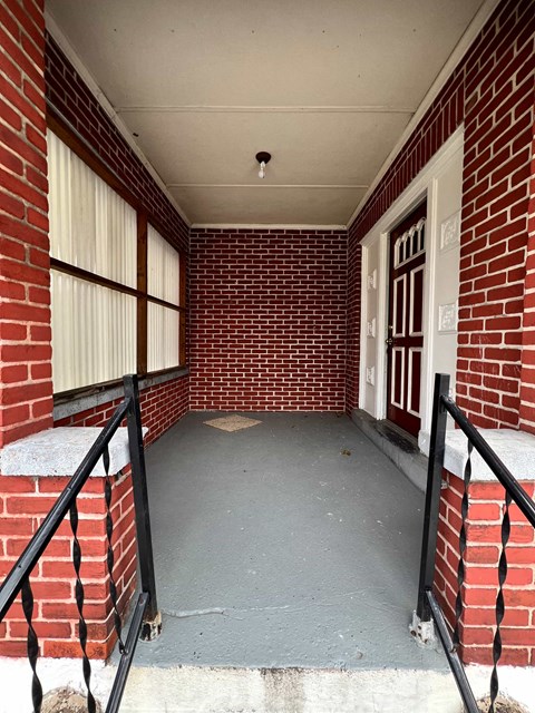 A small covered walkway between two brick buildings.