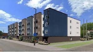 A row of modern apartment buildings are shown in the image.