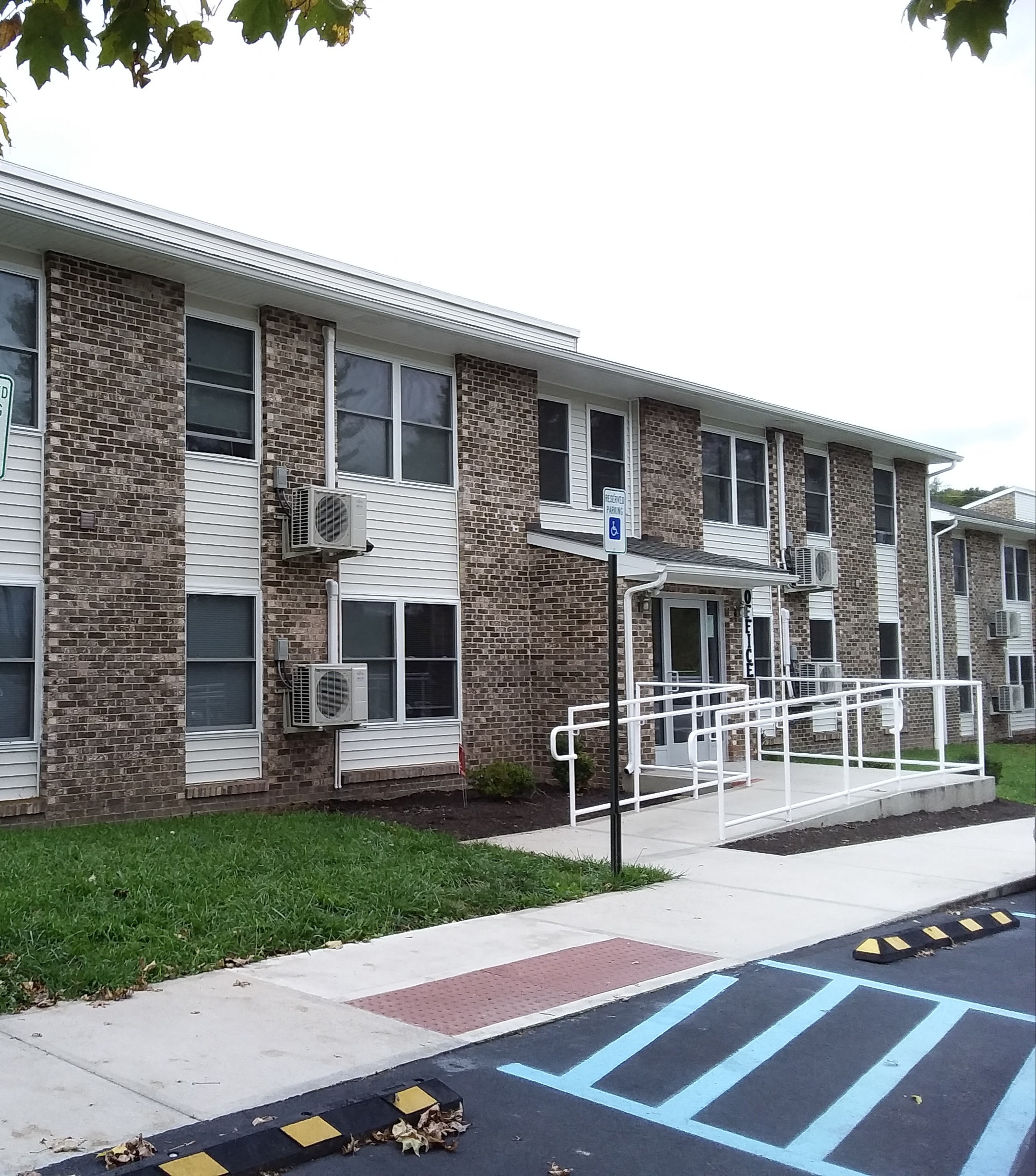 an apartment building with a ramp in front of it