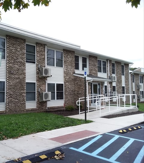 an apartment building with a ramp in front of it