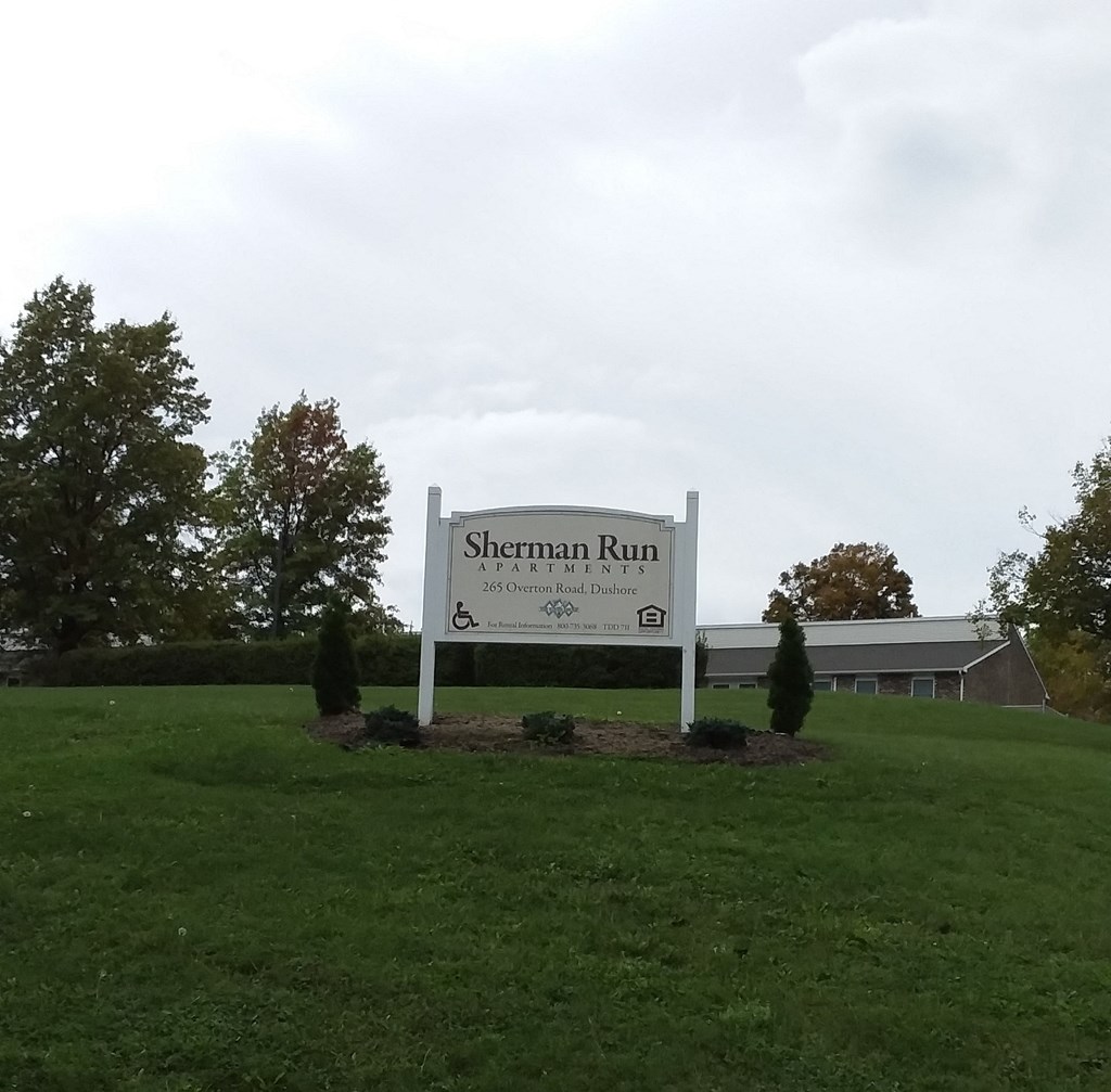 the sign in front of the sherman run building