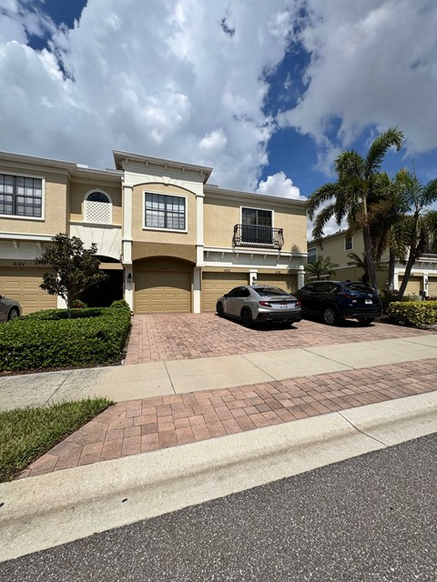 a house with two cars parked in front of it