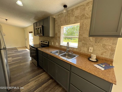 A kitchen with a sink and a window.