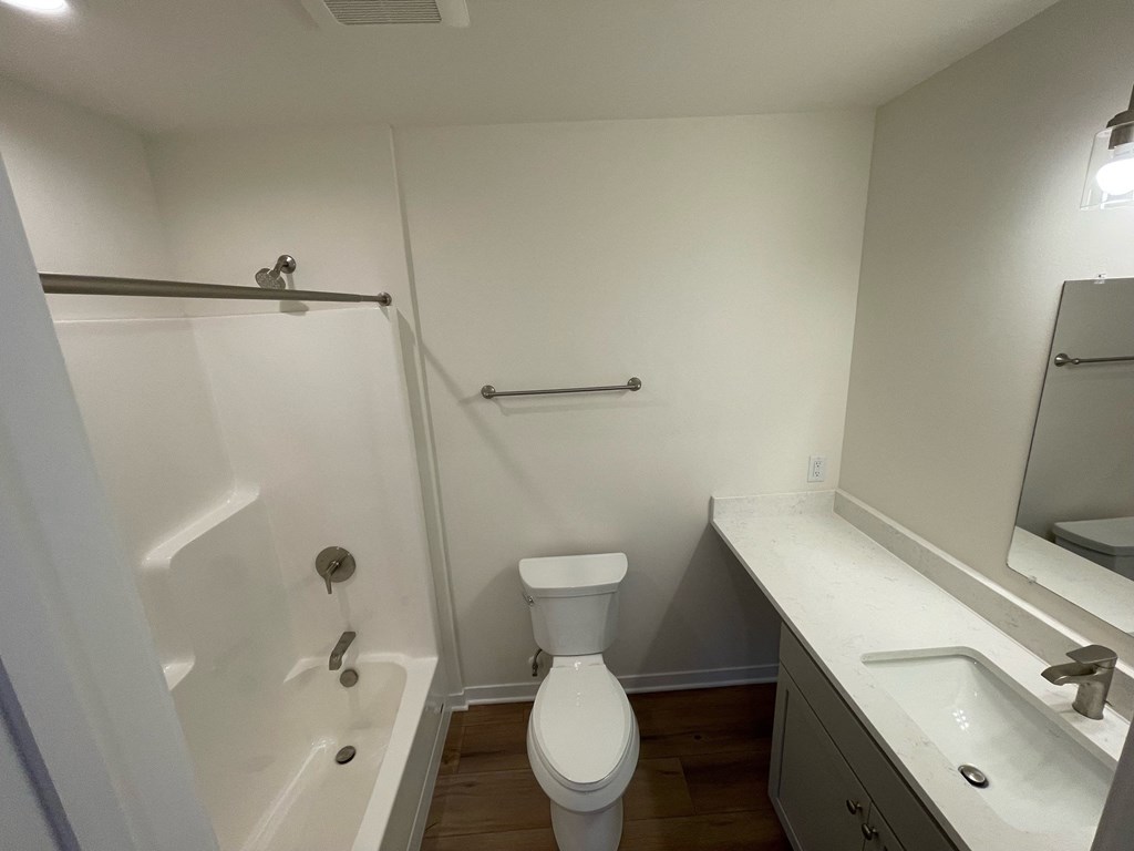 a small bathroom with a shower toilet and sink