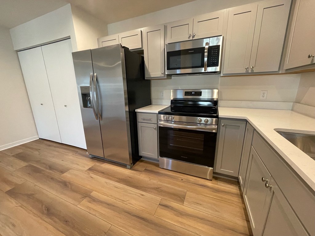a kitchen with stainless steel appliances and white cabinets