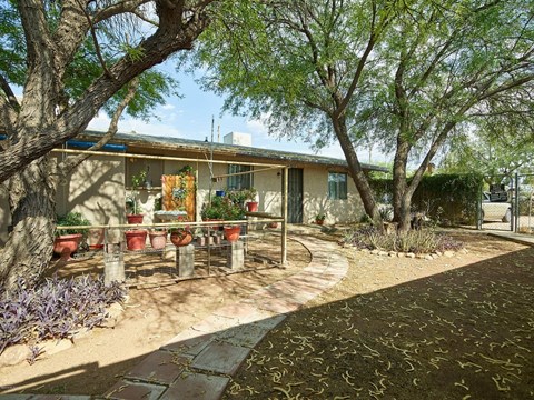 a patio in front of a house with trees