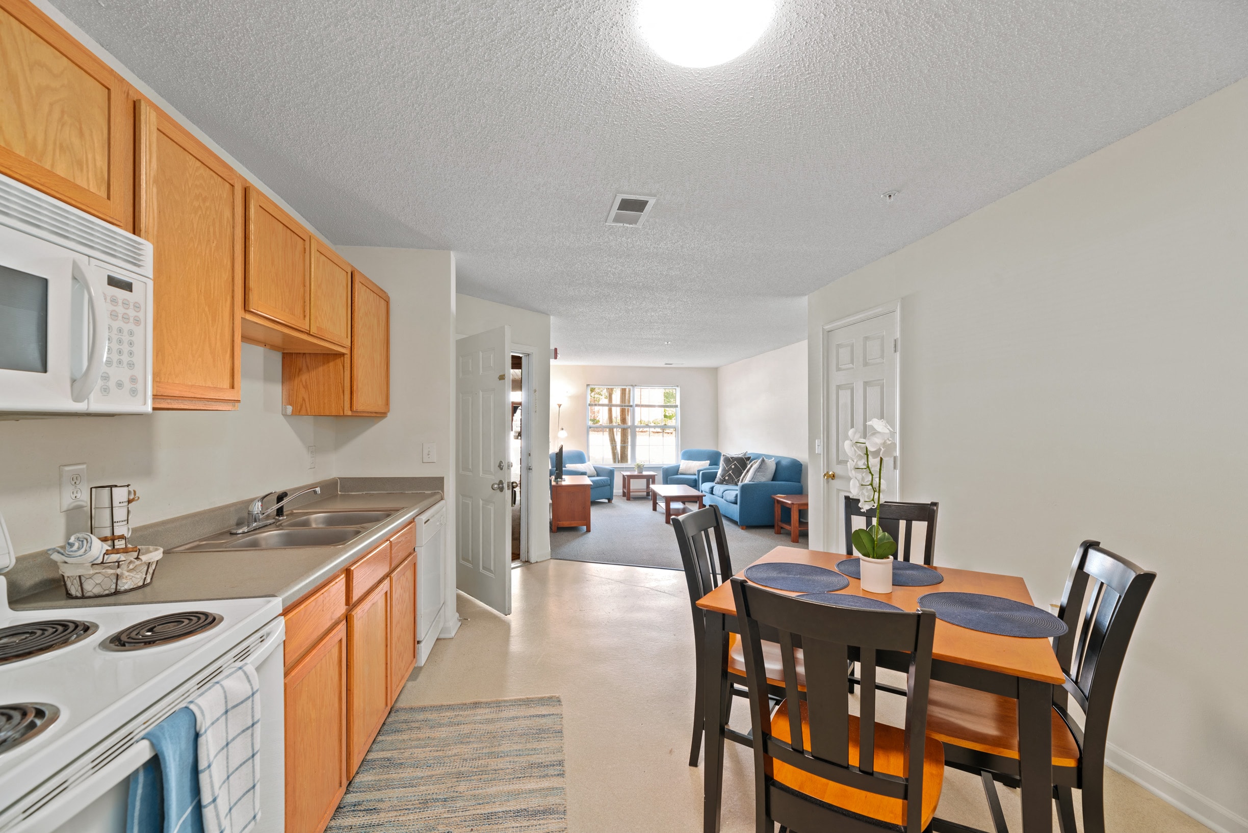 a kitchen and dining room with a dining table and chairs