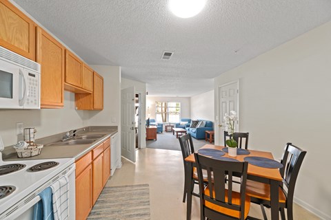 a kitchen and dining room with a dining table and chairs