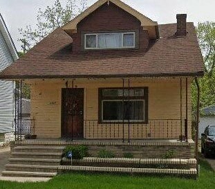 A small house with a brown door and a brown roof.