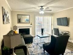 a living room with a couch a chair and a fireplace
