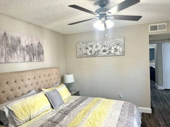a bedroom with a bed and a ceiling fan