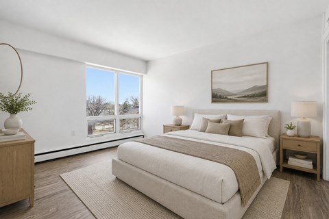 A bedroom with a large bed and a painting on the wall.