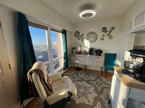 A kitchen with a chair and a window.