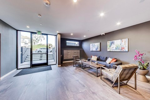 a living room with a couch and chairs and sliding glass doors