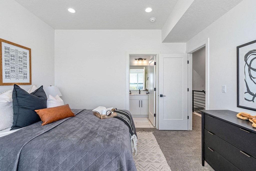 a bedroom with a bed and a door to a bathroom