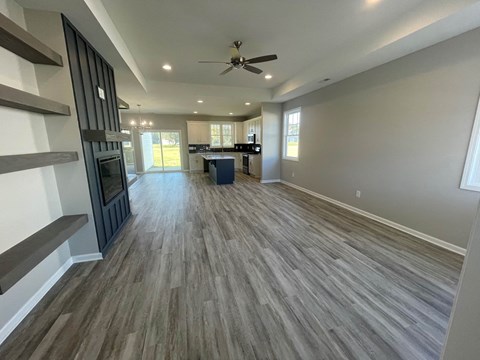 a living room with a wood floor and a ceiling fan