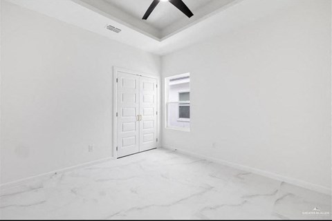 an empty room with white walls and a white door