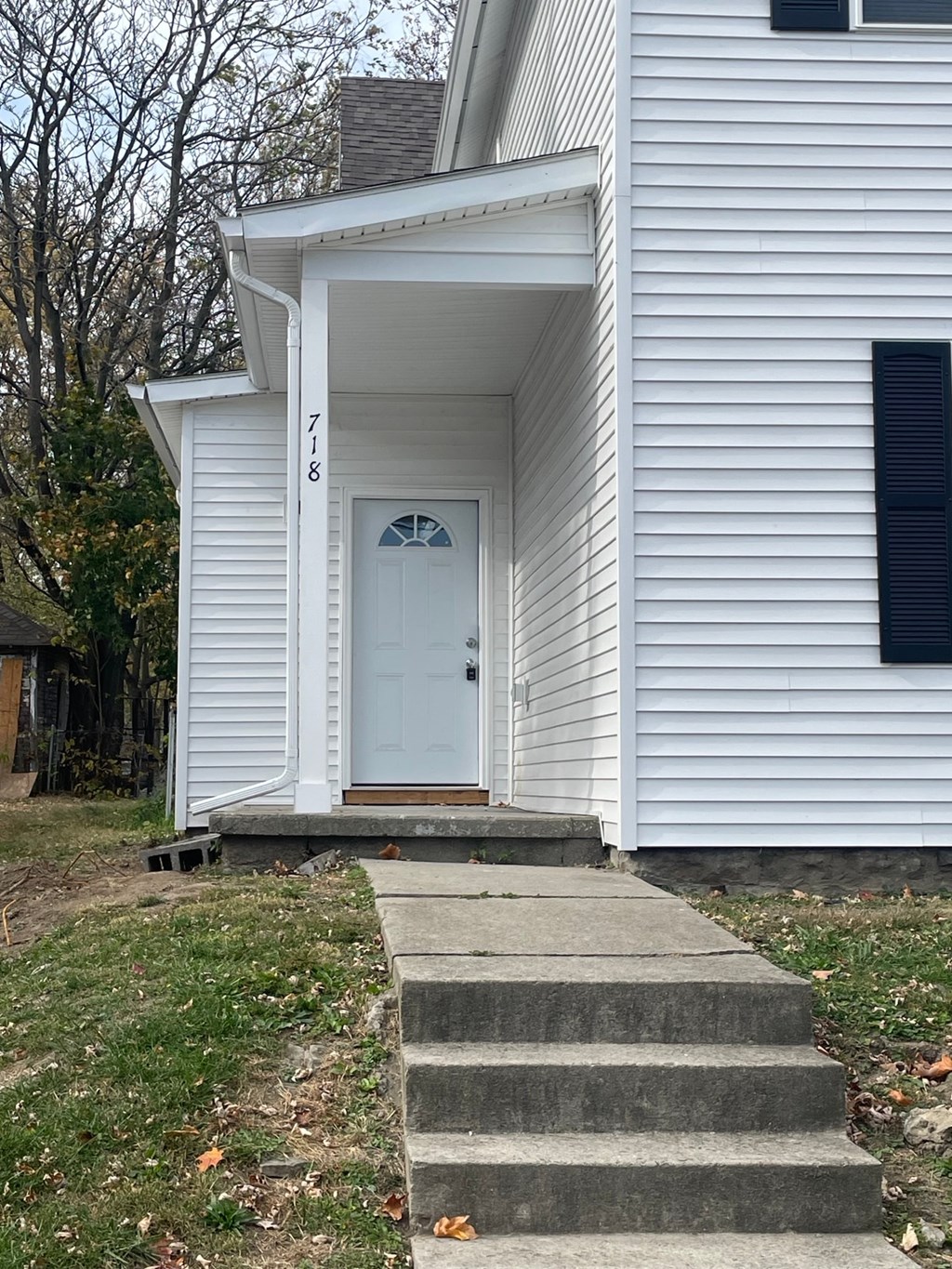 A white house with a black window and a white door.