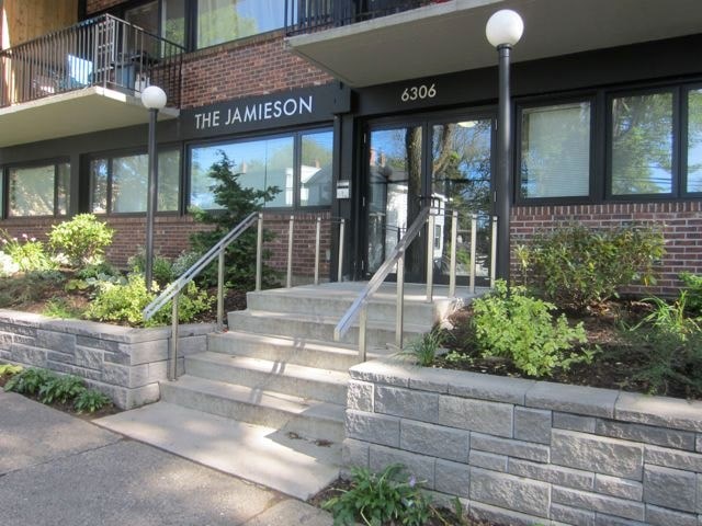 The Jamieson building has a black awning and a glass door.