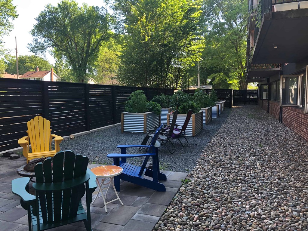 A patio with chairs and a table.