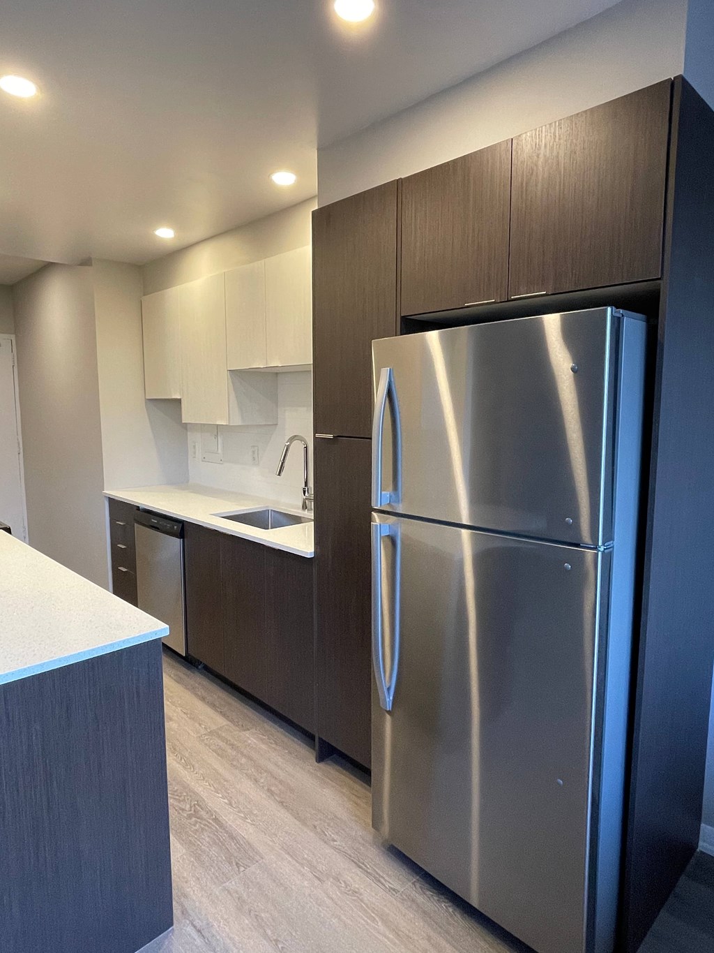 A modern kitchen with a stainless steel refrigerator.