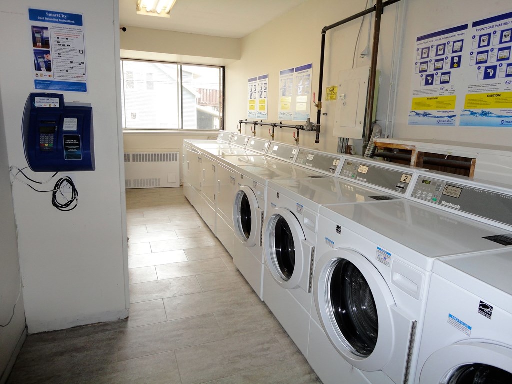 A row of washing machines in a laundromat.