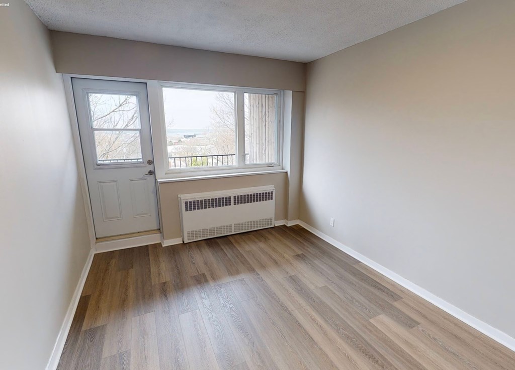 A room with a window and a door.