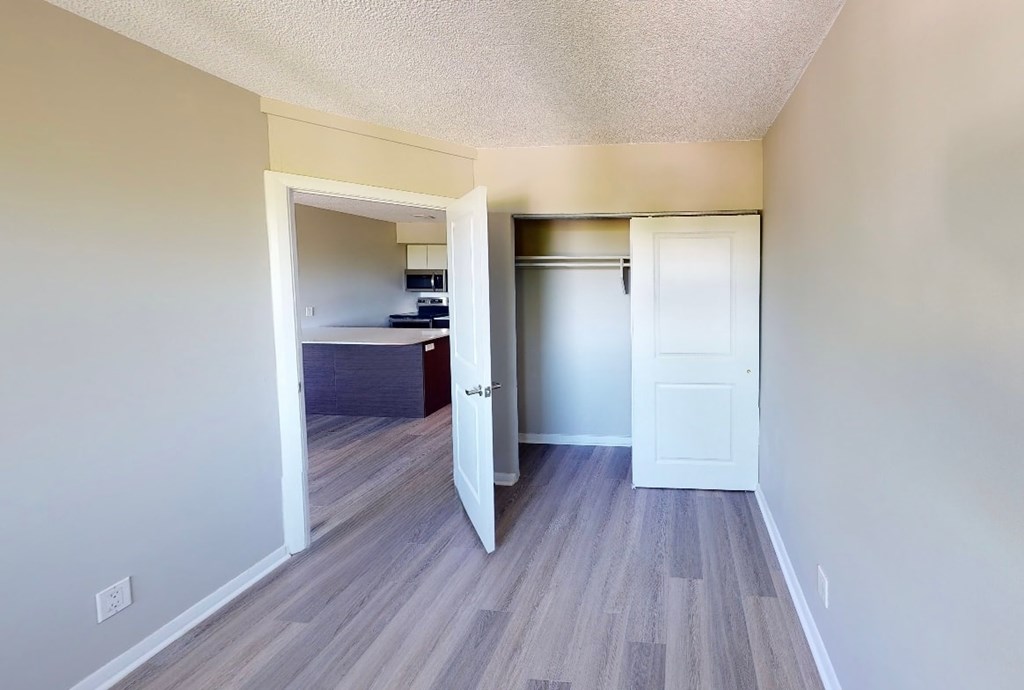 A room with a white door and a white wall.