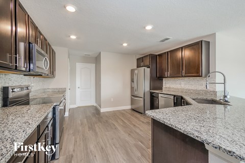 a kitchen with granite counter tops and stainless steel appliances