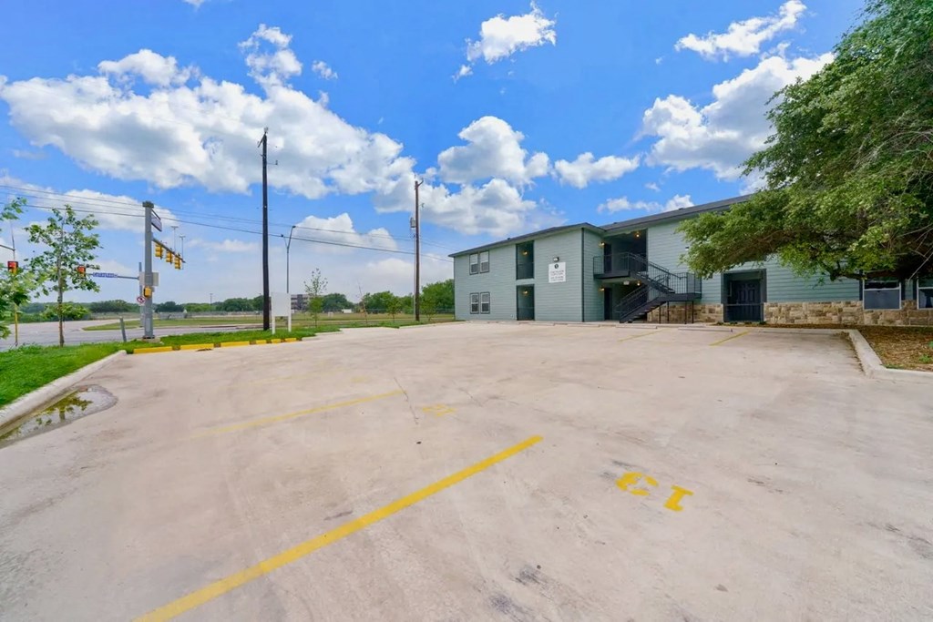 an empty parking lot in front of a building