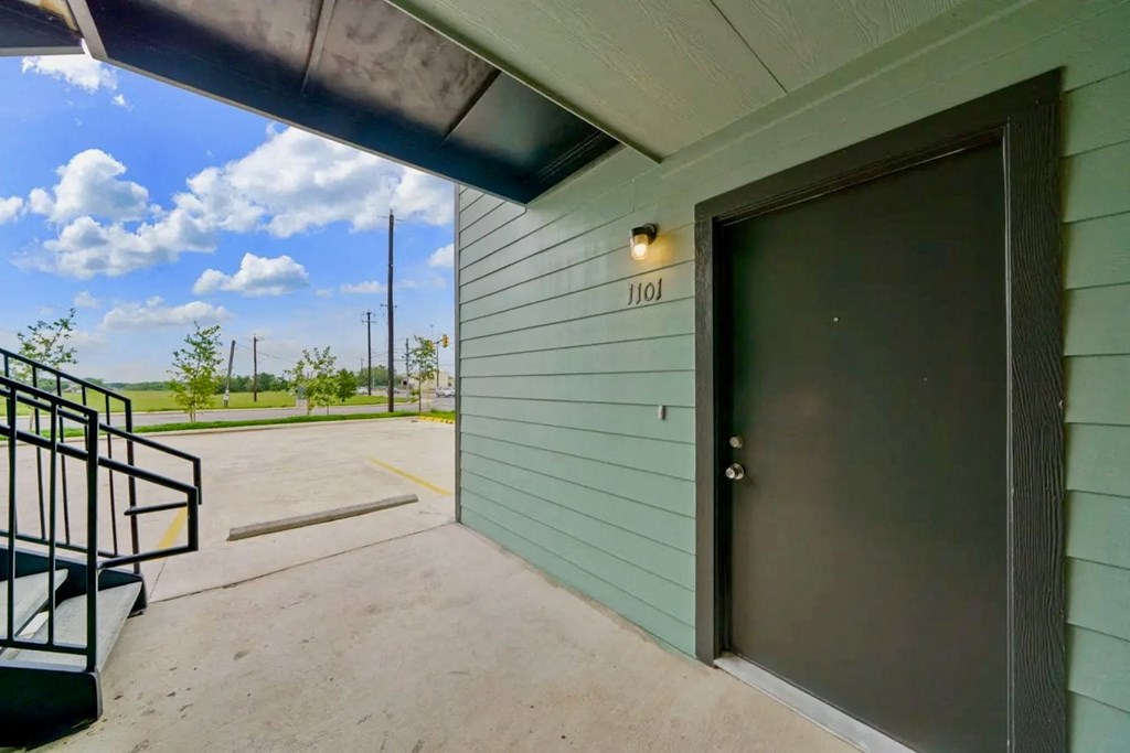 the front door of a building with a ramp leading up to it