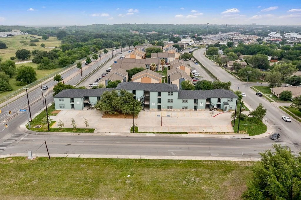 an aerial view of a group of houses on a city street