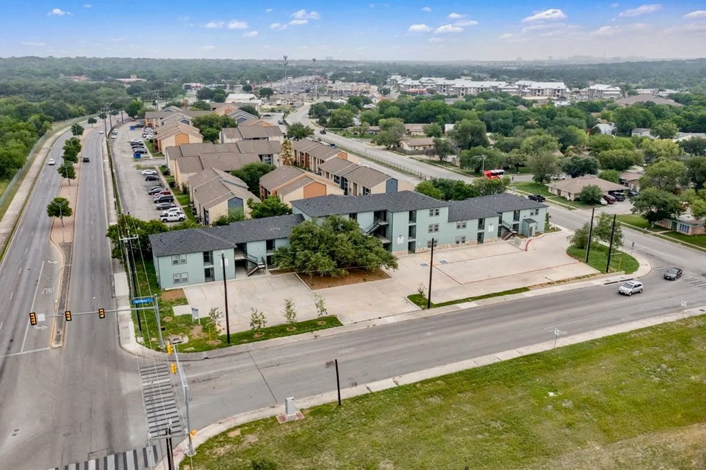 an aerial view of a neighborhood of houses on a city street