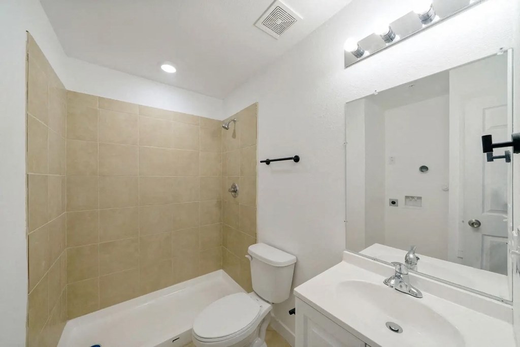 a bathroom with a sink toilet and a tub