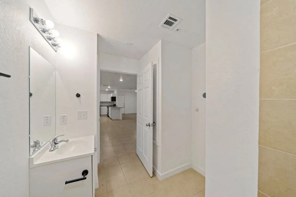 a bathroom with a sink and a mirror