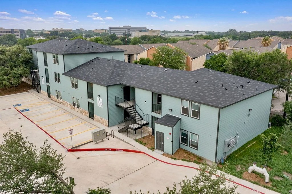 an aerial view of a blue building with a gray roof