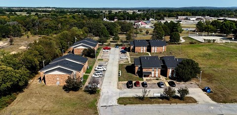 A large building complex with a parking lot in front.