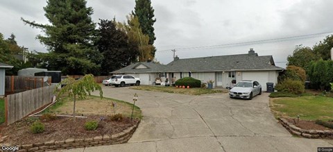 a house with cars parked in the driveway