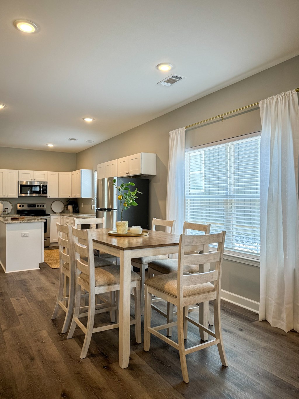 a dining room with a table and chairs in a kitchen