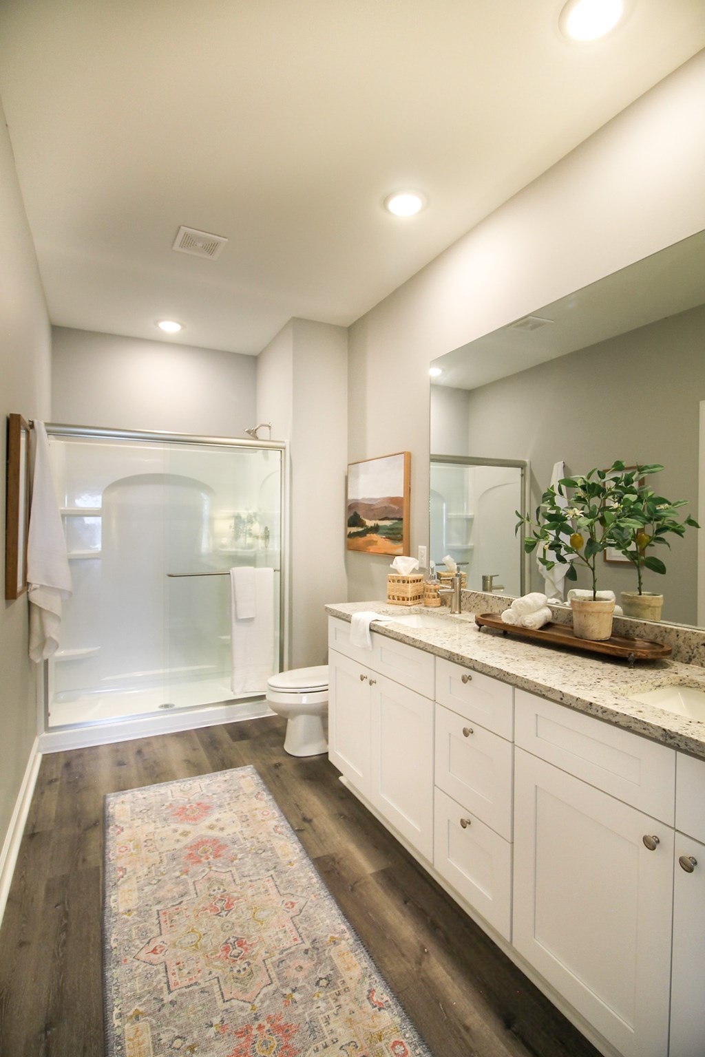 a bathroom with a shower and a sink and a mirror