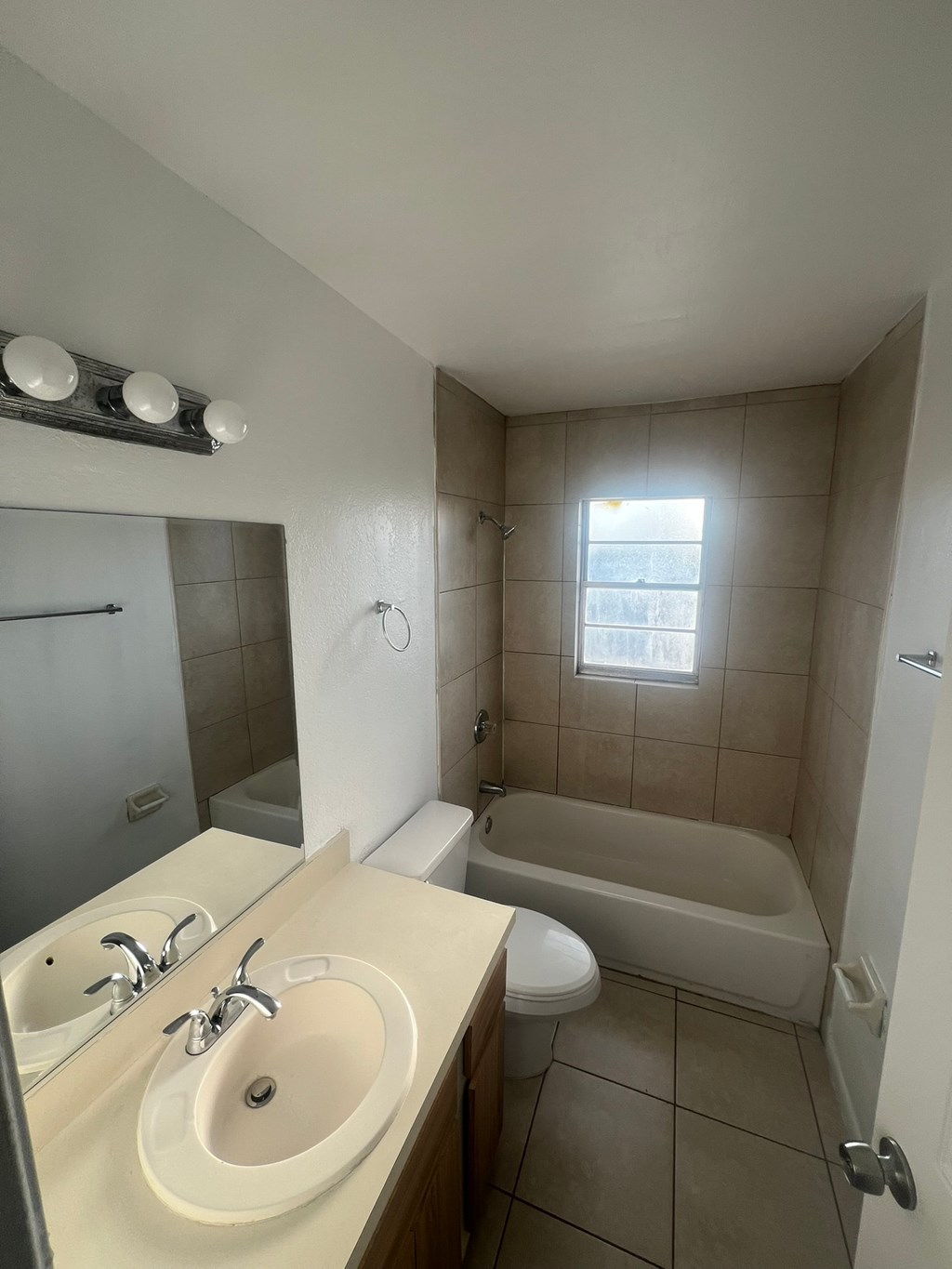 A small bathroom with a white sink and a bathtub.