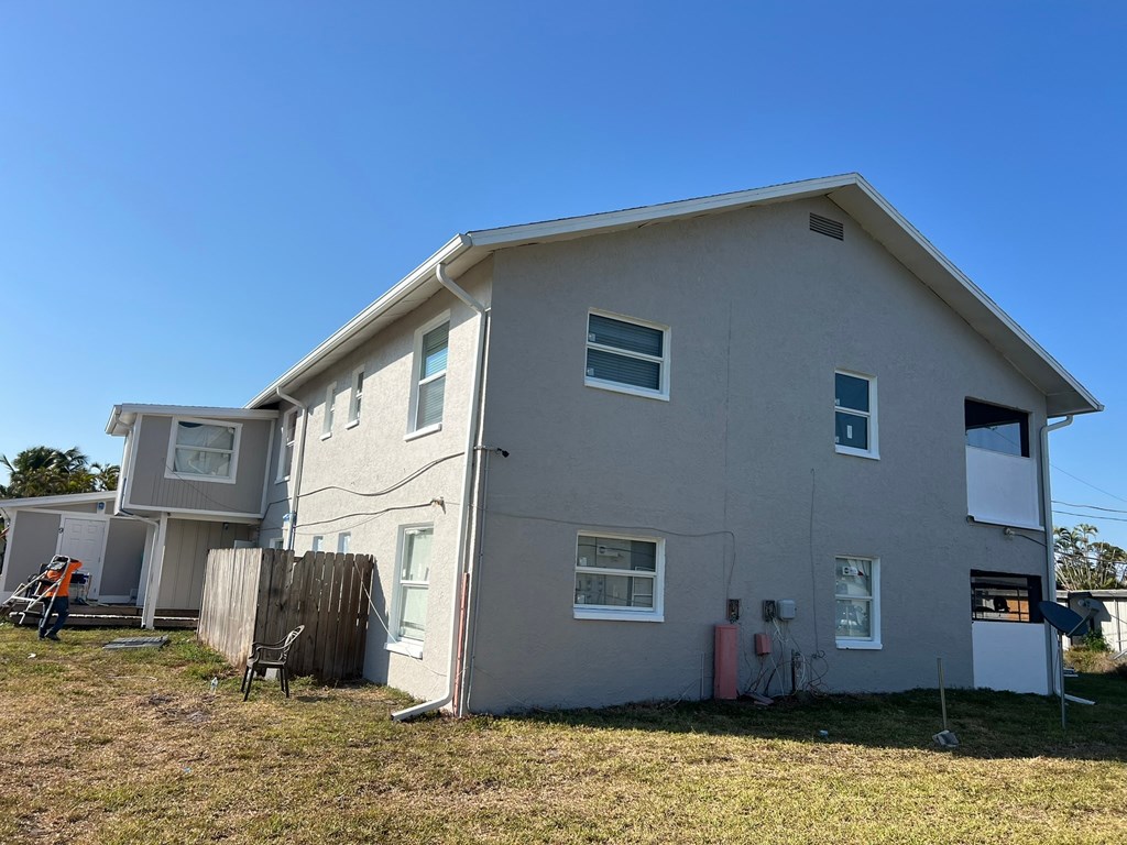 A house with a grey exterior and a white garage door.